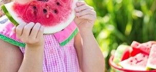 the girl eats a watermelon