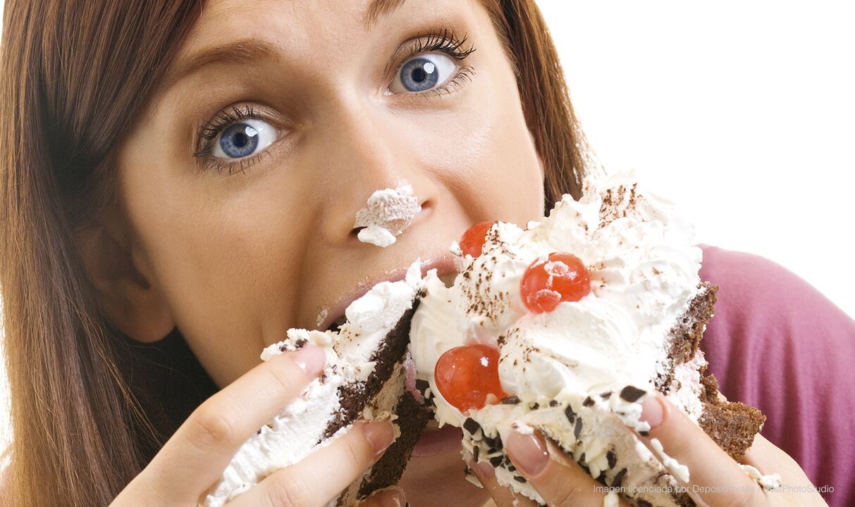 The girl eats a cake and improves how to lose weight